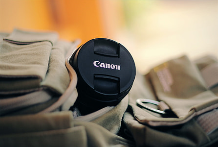 selective focus of black Canon telephoto lens on brown bag thumbnail