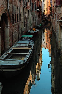 gray boat beside door thumbnail