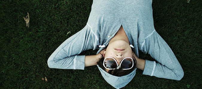 person laying on green grass thumbnail
