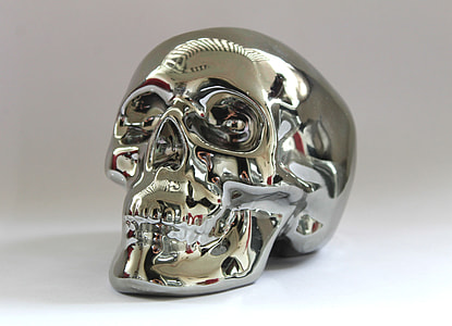 silver-colored skull accessory on white surface thumbnail