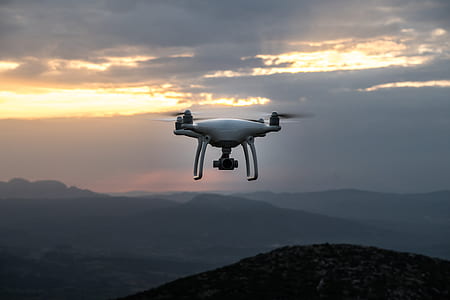 white qaudcopter drone hovering in the air thumbnail