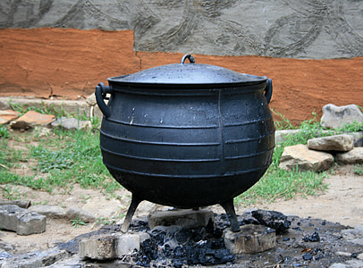 black cooking pot on three gray pavements at daytime thumbnail