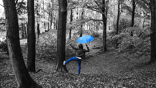 selective color photography of person holding umbrella thumbnail