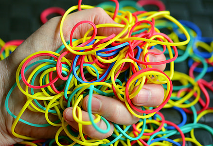 person holding assorted-colored loombands thumbnail