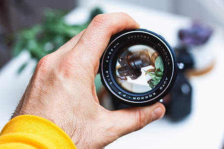 reflection of DSLR camera on black camera lens thumbnail