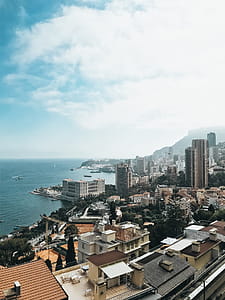 Aerial Photography of Buildings Near Sea Under Clear Blue Sky thumbnail