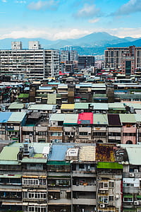 buildings with mountain at distant under blue sky thumbnail