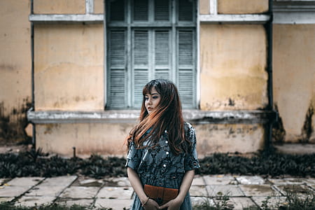 woman standing near high-rise building thumbnail