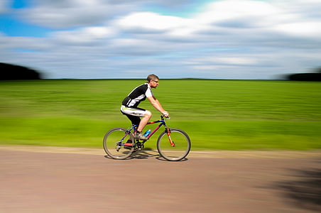 person biking during day time thumbnail
