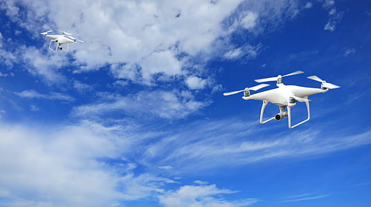 two white quadcopters thumbnail