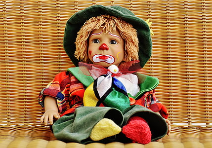 doll wearing green clothes on brown woven surface thumbnail