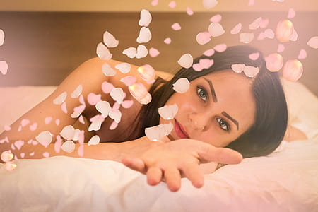 woman lying on bed with rose petals thumbnail