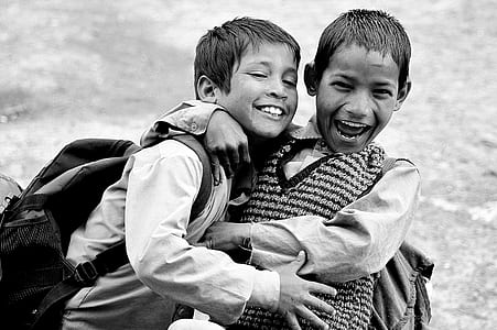 grayscale photography of children hugging each other thumbnail