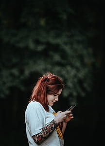 selective focus photography of woman using smartphone thumbnail