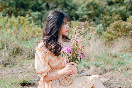 Woman In Dress Holding Flowers thumbnail