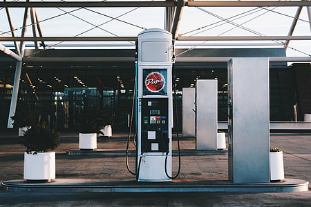 white and red vending machine near plant at daytime photo thumbnail