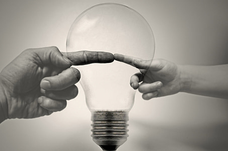 grayscale photo of human finger with light bulb thumbnail