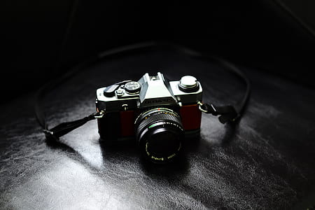 black DSLR camera on black surface thumbnail