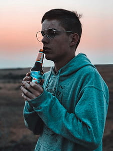 man holding beer bottle thumbnail