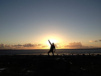 silhouette of man on beachshore during sunset thumbnail