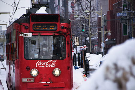 Coca-Cola cable train near buildings during day thumbnail