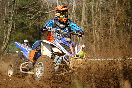 person riding on blue and white ATV thumbnail