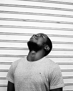 Grayscale Photo of Man Wearing Tommy Hilfiger Shirt thumbnail