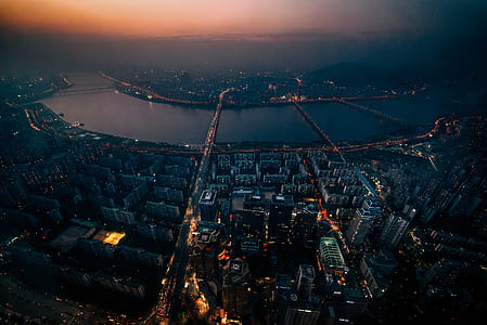 aerial photography of buildings near body of water during dawn thumbnail