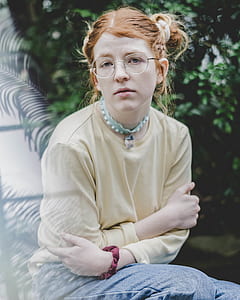 sitting woman wearing gray long-sleeved shirt during daytime thumbnail