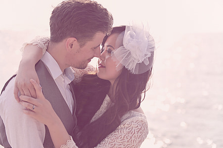 man wearing gray vest with woman in white floral long-sleeved top thumbnail