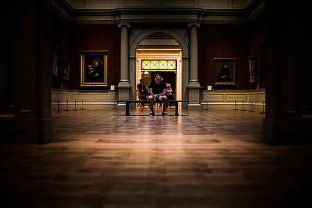 man sitting on chair inside building thumbnail