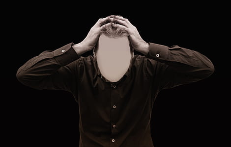 man holding head while standing thumbnail