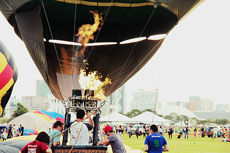 people near hot-air balloon and tents thumbnail
