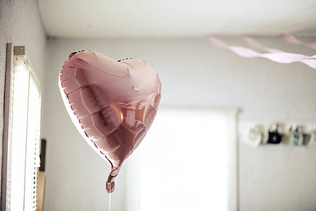 pink heart balloon in white room thumbnail