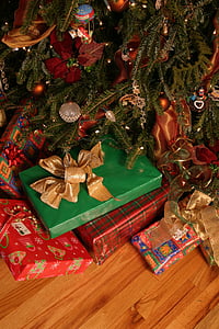 assorted gift boxes beside christmas tree thumbnail