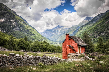 red and black brick house surrounded by mountains thumbnail