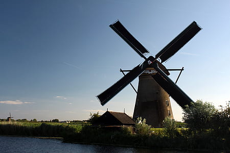 windmill near body of water thumbnail