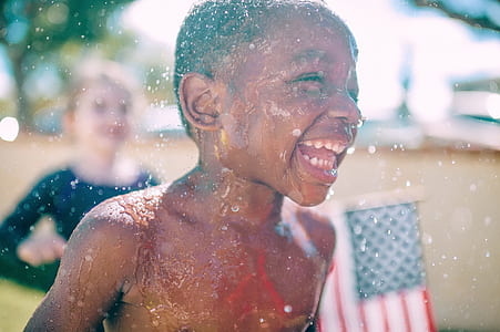 boy takes a bath in rain at daytime thumbnail