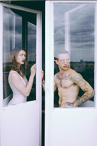 man and woman standing on white framed glass door thumbnail