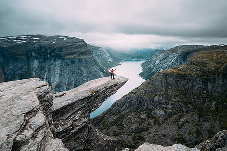 person lifting hand on mountain thumbnail
