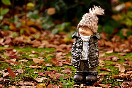 boy wearing black bubble jacket and knit cap figurine thumbnail