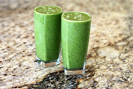 two clear glass cup full of green smoothie thumbnail