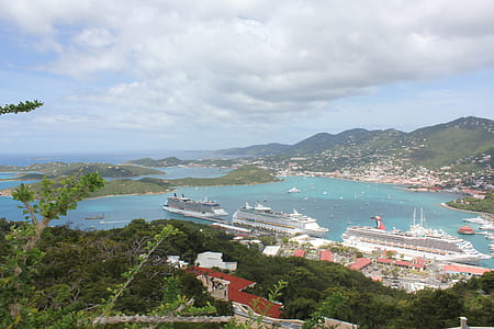 aerial photo of three white cruise ships on body of water near green mountains thumbnail