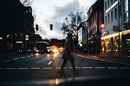 person walking on street during nighttime thumbnail