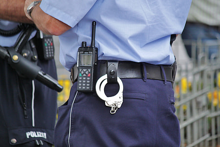 police with handcuffs on black leather belt thumbnail