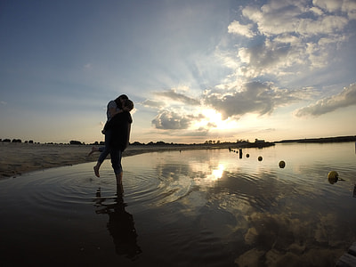 couple standing on body of water thumbnail