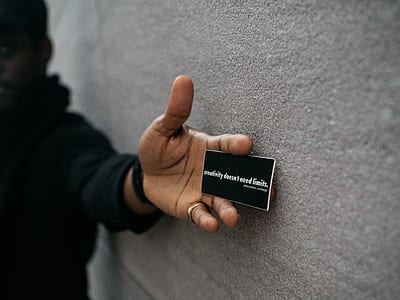person holding white business card near wall thumbnail