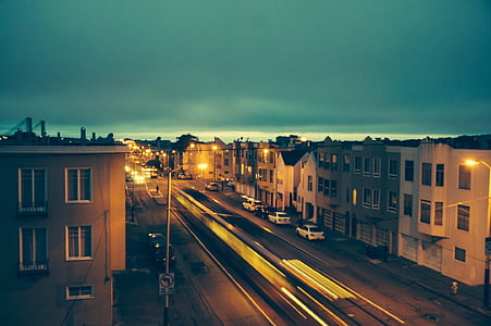 car passing through road between houses thumbnail