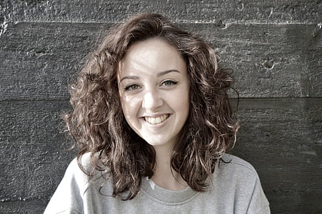 woman smiling near the wall thumbnail