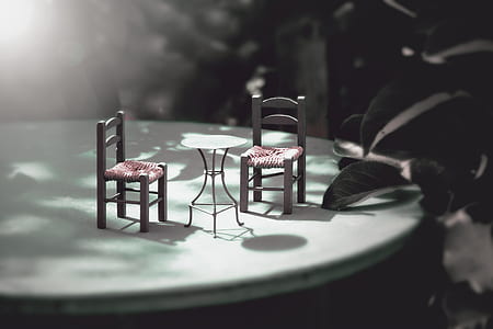 two grey-and-red chairs and one round table miniatures on round grey table thumbnail